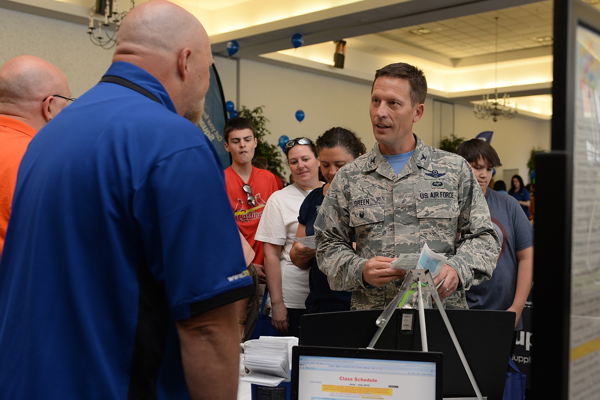 Col. Gregory Green, 375th Air Mobility Wing vice commander, stops by the Arts and Crafts Center's booth at the base picnic June 26, 2015 at Scott Air Force Base, Ill. The base picnic was hosted by the 375th Force Support Squadron, but with the help of many sponsors from the local community. Families were able to enjoy free food, drinks, snacks, ice cream, popcorn and many more treats. (U.S. Air Force photo/ Airman 1st Class Kiana Brothers)