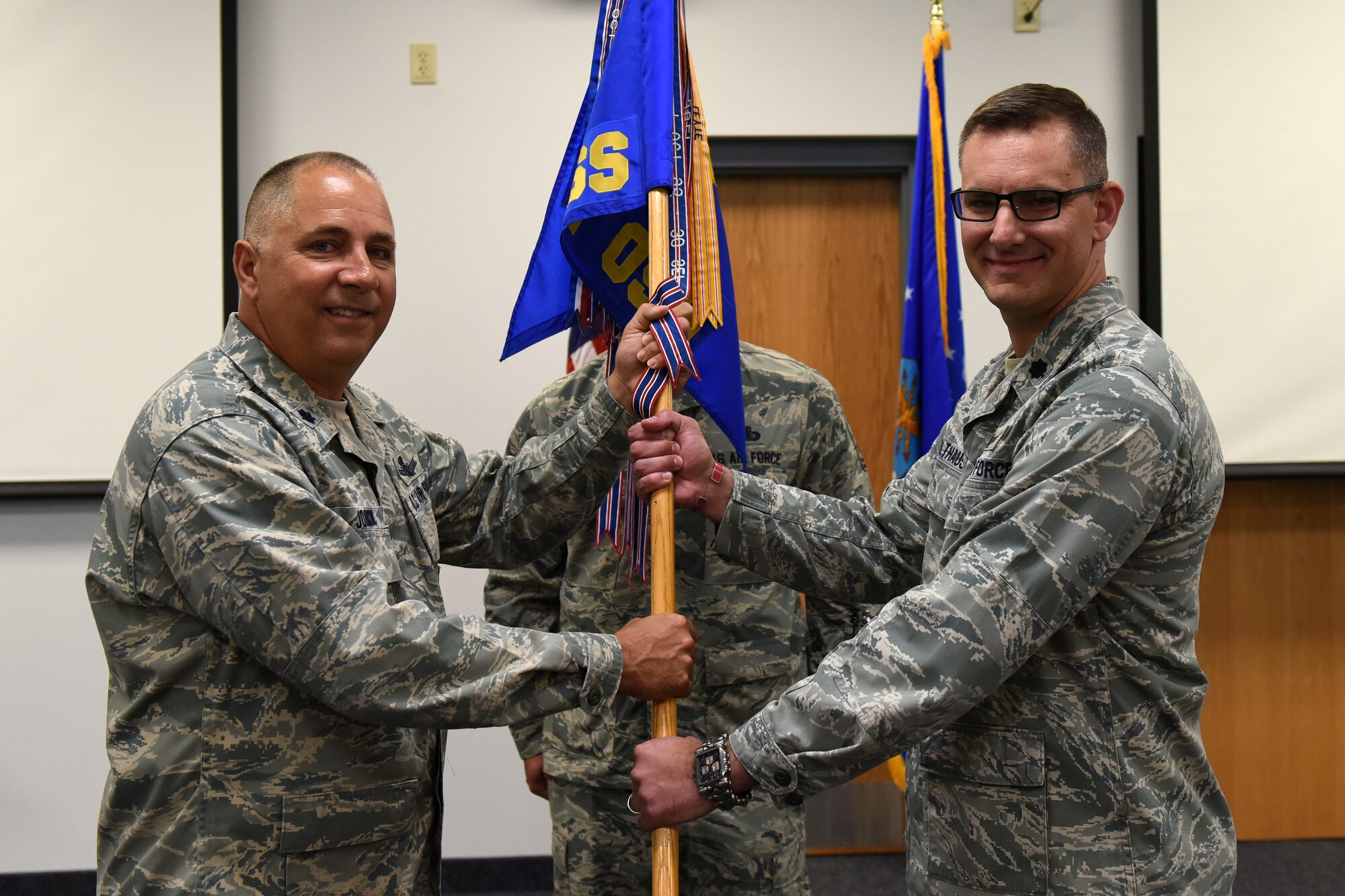 Lt. Col. Austin Holthaus, right, accepts command of the 341st Operations Support Squadron from Lt. Col. Jeffrey Johnson, 341st Operations Group deputy commander, July 1, 2015, at Malmstrom Air Force Base, Mont. (U.S. Air Force photo/Chris Willis)