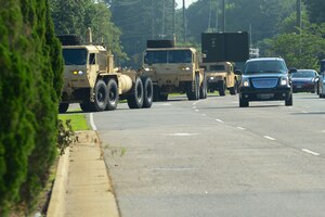 A convoy line of military vehicles approaches Fort Eustis, Va., June 25, 2015. The convoy was part of a ceremony celebrating the completion of construction on Route 105 Fort Eustis Boulevard Bridge. (U.S. Air Force photo by Senior Airman Kimberly Nagle)