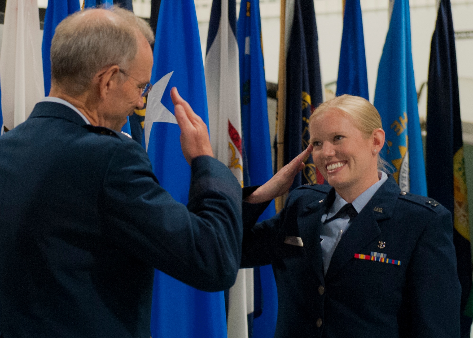 Capt. Pamela Waters, 96th Medical Operations Squadron, salutes Air Force Surgeon General, Lt. Gen. Mark Ediger, after receiving her graduation certificate June 26 at the Air Force Armament Museum near Eglin Air Force Base, Fla. Waters was one of nine physicians who graduated from Eglin’s Family Medicine Residency Program.  (U.S. Air Force photo/Ilka Cole)  