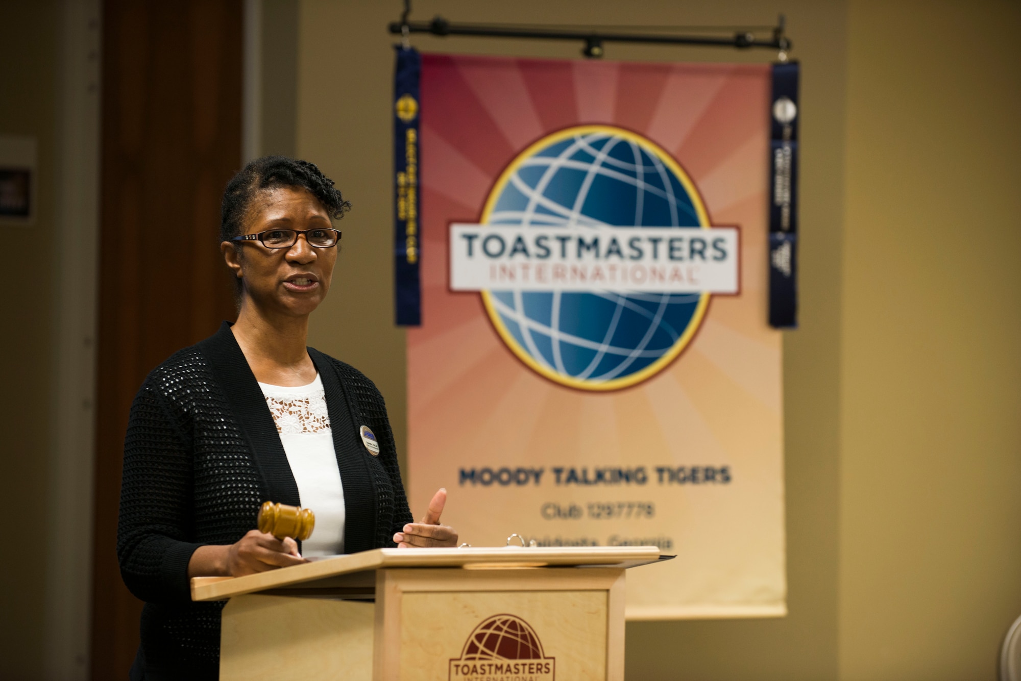 Emanuella McCall, outgoing Moody Talking Tigers president, speaks before the 2015 MTT inauguration ceremony June 25, 2015, at Moody Air Force Base, Ga. Jerry Bullard, 23d Civil Engineer Squadron locksmith, replaced McCall as the new MTT president. (U.S. Air Force photo by Airman 1st Class Dillian Bamman/Released)