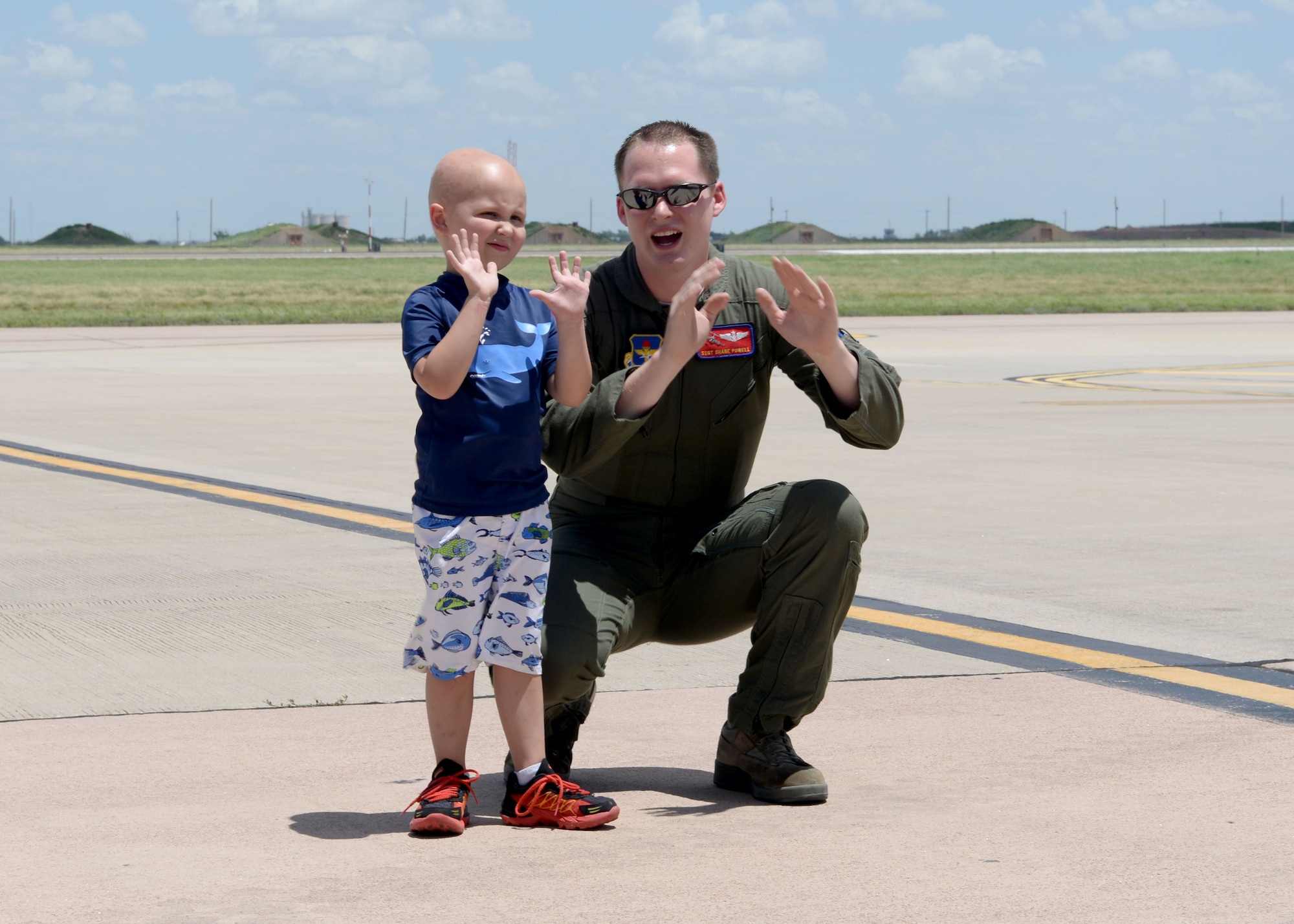 ALTUS AIR FORCE BASE, Okla. – U.S. Air Force Staff Sgt. Shane Powell, 58th Airlift Squadron loadmaster, shows Jaxon Dugger how to back a truck into a U.S. Air Force C-17 Globemaster III cargo aircraft on the flightline, June 26, 2015. Ewing’s sarcoma is a cancer found primarily in the bones and soft tissue, but Jaxon is of two percent of those with it found in his brain.  (U.S. Air Force photo by Airman 1st Class Kirby Turbak/Released))