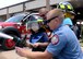 ALTUS AIR FORCE BASE, Okla. – Jaxon Dugger sprays a fire hose with members of the 97th Civil Engineer Squadron fire department at the fire house, June 26, 2015. Members of the 97th CES fire department also drove Jaxon from the front gate to the 58th Airlift Squadron that morning for his Pilot for a Day mission briefing. (U.S. Air Force photo by Airman 1st Class Kirby Turbak/Released)