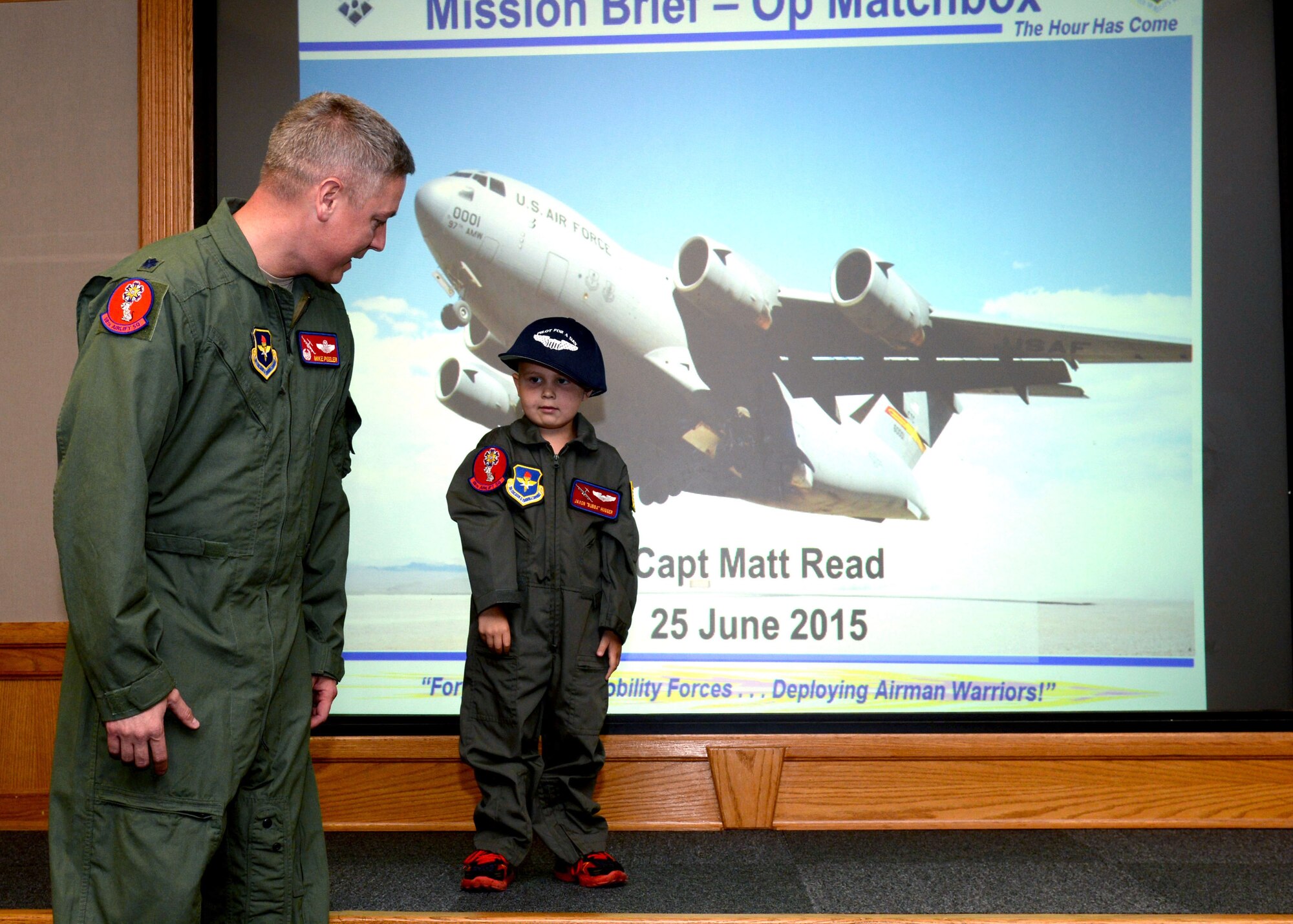 ALTUS AIR FORCE BASE, Okla. – U.S. Air Force Lt. Col. Mike Peeler, 58th Airlift Squadron commander, introduces Jaxon Dugger during a Pilot for a Day event at the 58th AS briefing room, June 26, 2015. The Pilot for a Day program allows a child who survived or was diagnosed with a serious illness to see some of the everyday experiences of Airmen at Altus AFB. (U.S. Air Force photo by Airman 1st Class Kirby Turbak/Released)