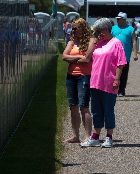 Desiree Cummings, left, and Kristen Gertge visit a replica of the Vietnam Veterans Memorial Wall, part of the American Veterans Traveling Tribute visiting Lions Park, June 25, 2015, in Cheyenne, Wyo. Airmen from F.E. Warren Air Force Base volunteered time to help put the displays together. (U.S. Air Force photo by R.J. Oriez)