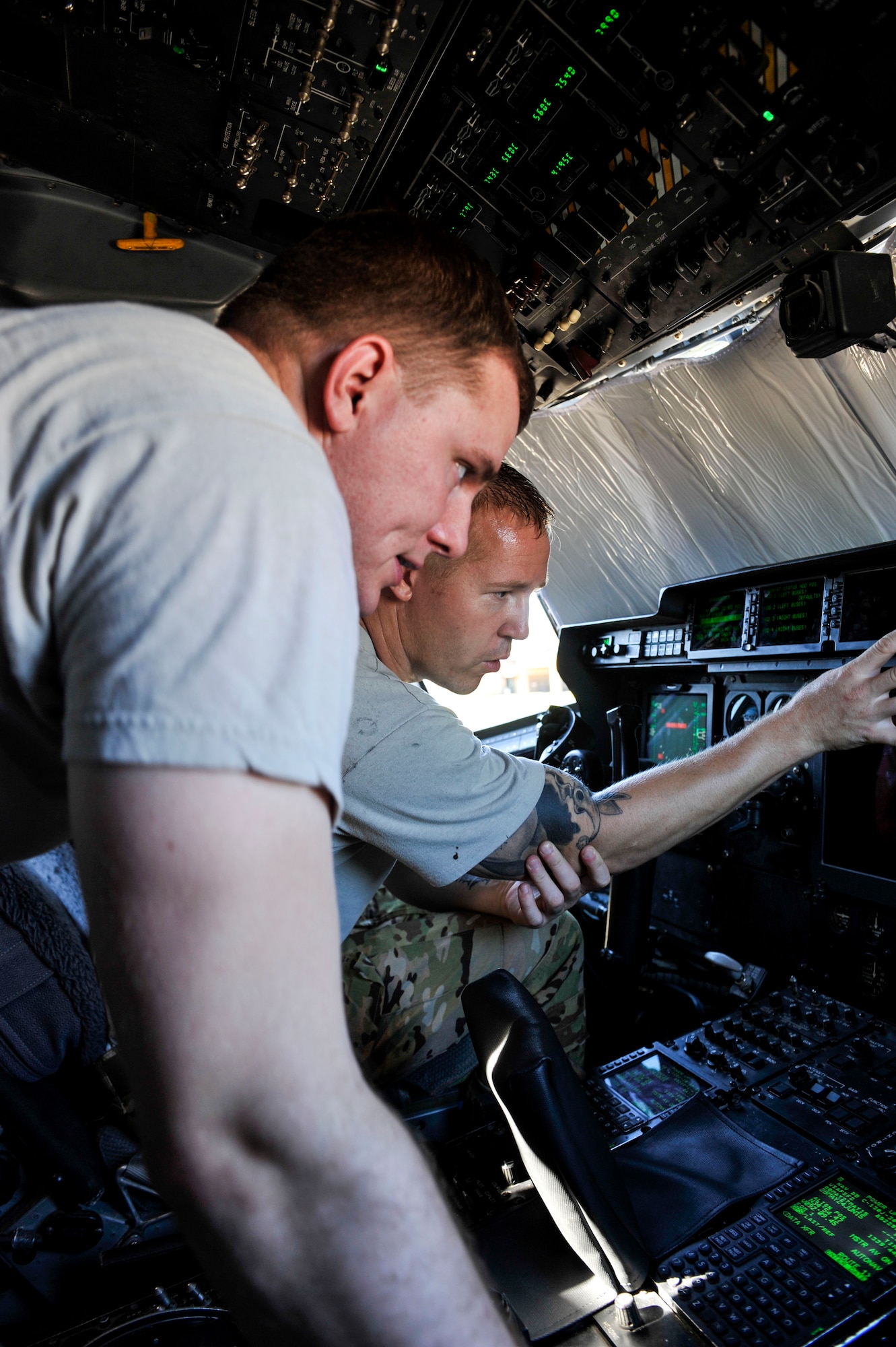 Senior Airman Timothy Cullen, a 19th Aircraft Maintenance Squadron electronic and environmental systems journeyman, and Staff Sgt. Joshua Jorgensen, a 19th AMXS crew chief, troubleshoot a warning light June 9, 2015, at Little Rock Air Force Base, Ark. After reloading software to an electronic circuit breaker unit, the issue was resolved. (U.S. Air Force photo by Senior Airman Stephanie Serrano)