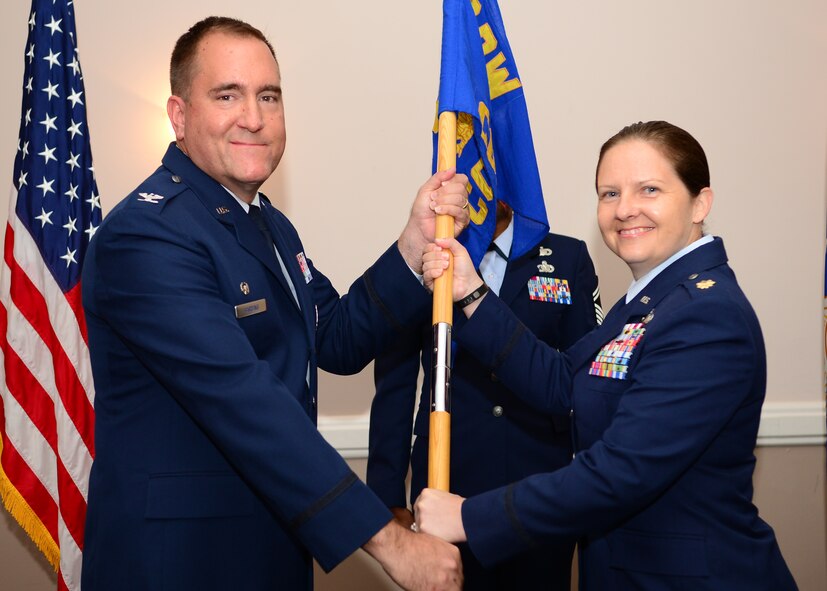 Maj. Jennifer McGee assumes command of the 2nd Contracting Squadron from Col. Craig Harding, 2nd Mission Support Group commander, during a change of command ceremony on Barksdale Air Force Base, La., June 30, 2015. McGee commissioned into the Air Force Nov. 15, 2001, and has held contracting positions in operational, specialized and systems contracting organizations. Prior to joining the 2nd CS, McGee was a student at the Air Command and Staff College, Maxwell Air Force Base, Ala. (U.S. Air Force photo/Senior Airman Benjamin Raughton)
