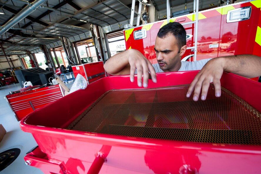 U.S. Air Force Airman 1st Class Nigell McAlpin, 23d Logistics Readiness Squadron special vehicle maintenance journeyman, prepares to perform an oil change June 30, 2015, at Moody Air Force Base, Ga. More than 40 Airmen and civilians from the 23d LRS Vehicle Management Flight hold the responsibility of maintaining mission readiness for 470 vehicles. (U.S. Air Force photo by Airman 1st Class Dillian Bamman/Released)