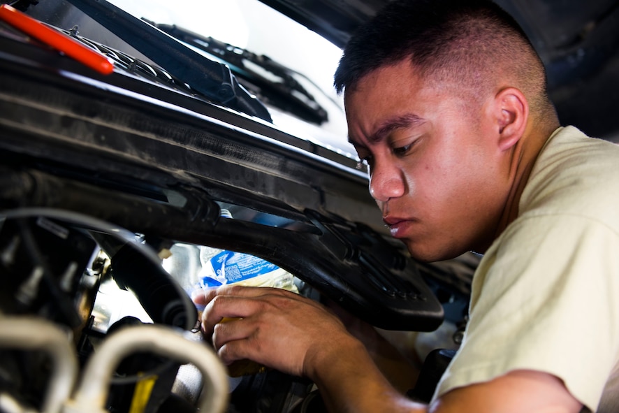 U.S. Air Force Airman 1st Class Ryan Abella, 23d Logistics Readiness Squadron vehicle maintenance journeyman, checks an oil system in a government operated vehicle June 30, 2015, at Moody Air Force Base, Ga. The 23d LRS Vehicle Management Flight is tasked to analyze and repair numerous Moody vehicles, including 23d Civil Engineer Squadron fire trucks and 23d Security Forces Squadron police vehicles. (U.S. Air Force photo by Airman 1st Class Dillian Bamman/Released)