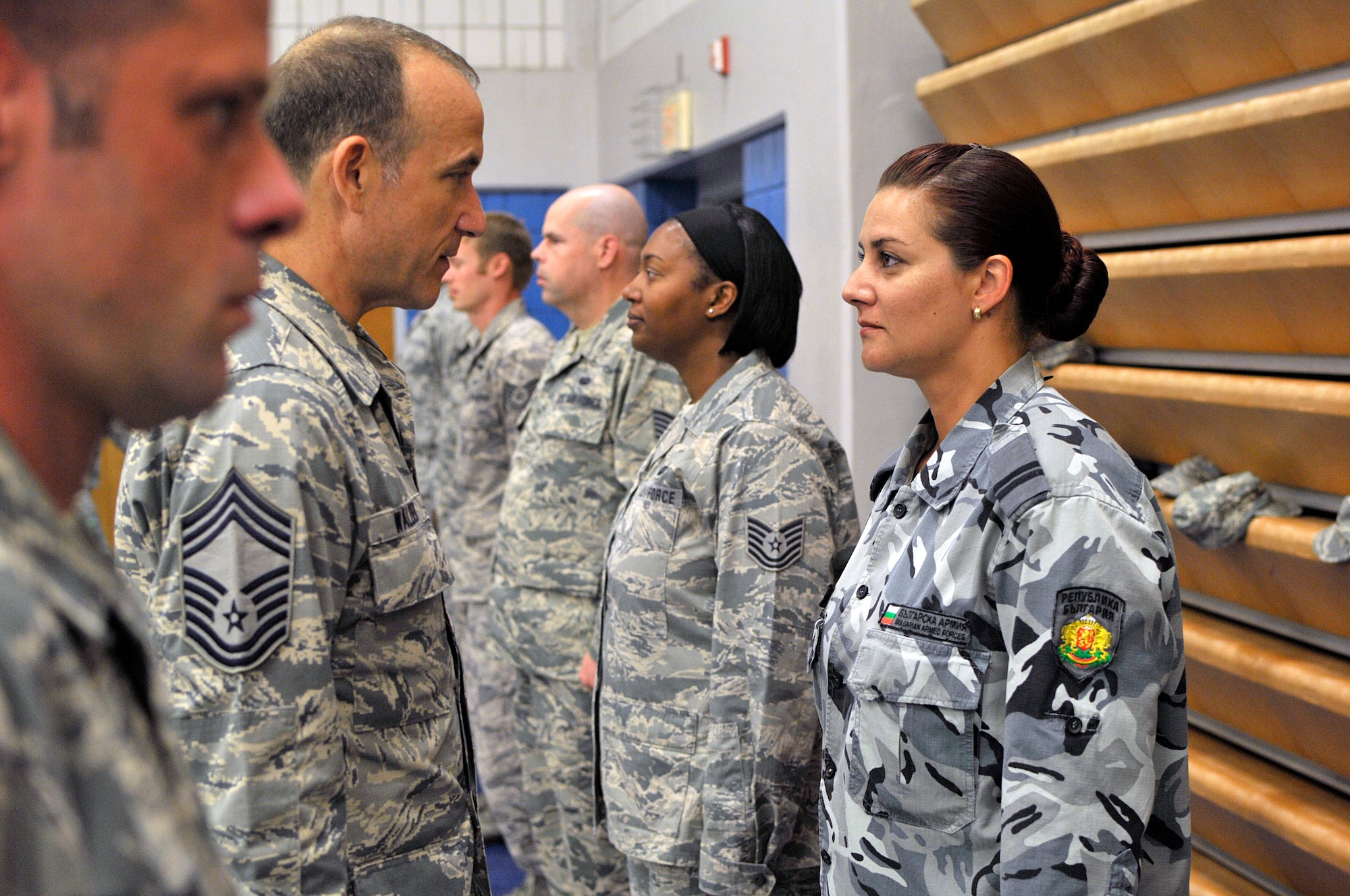 MCGHEE TYSON AIR NATIONAL GUARD BASE, Tenn. - Chief Master Sgt. Edward Walden, Sr., commandant of the Paul H. Lankford Enlisted PME Center, inspects the uniform of Bulgarian Staff Sgt. Bistra Koleva Kumanova here, June 23, 2015, during a uniform inspection in NCO academy. The EPME center hosts international military students from Bulgaria as well as from Canada and Jordan. (U.S. Air National Guard photo by Master Sgt. Mike R. Smith/Released)  