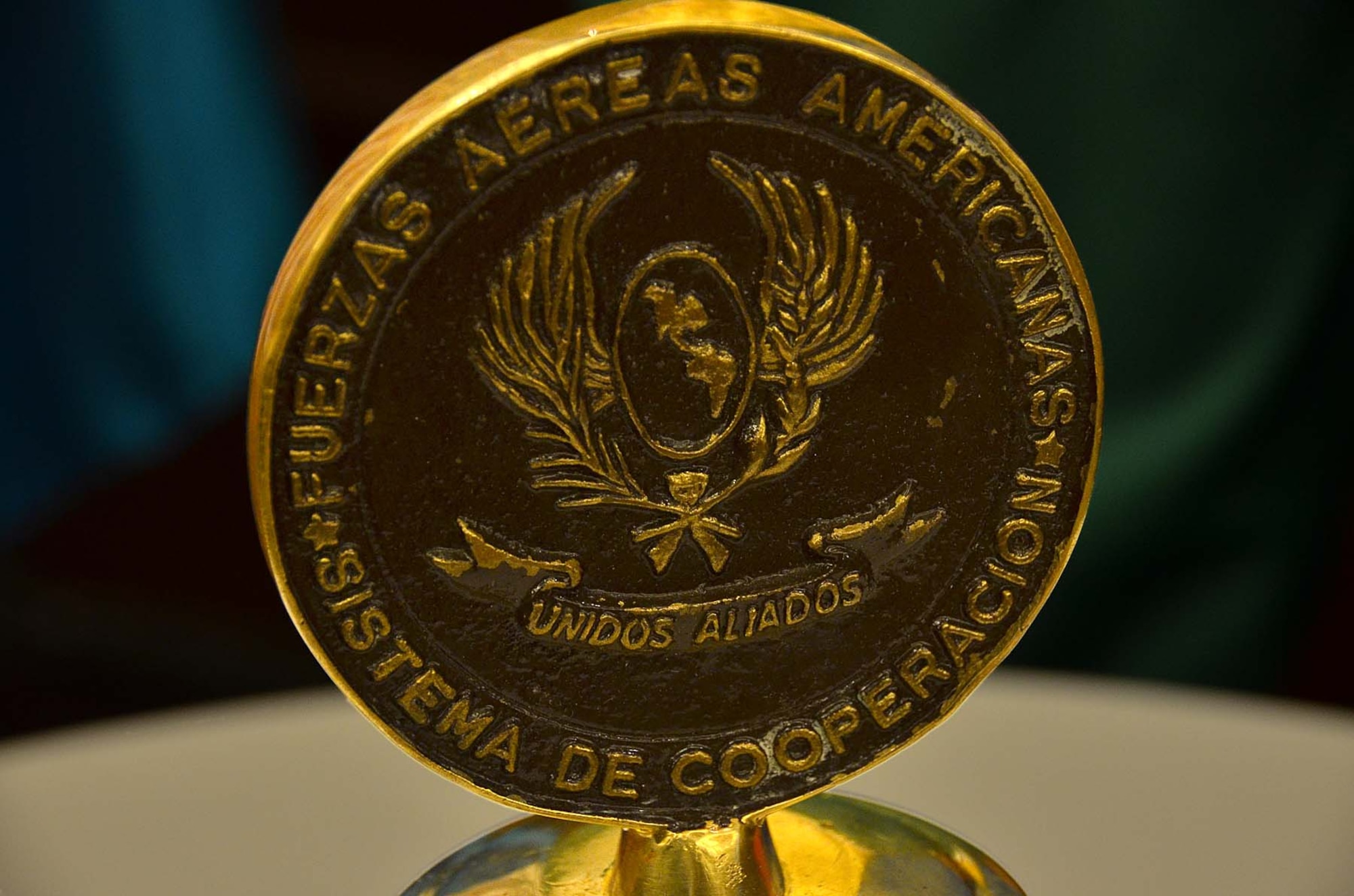 Pictured is the crown of the bell of the System of Cooperation Among the American Air Chiefs, which is rung by the leader of the host nation air force holding the annual Conference of the American Air Chiefs to both open and close the session. In its 55th year, SICOFAA is made up of 20 air forces whose representatives meet regularly to enhance interoperability and make agreements about how the countries will potentially operate jointly, primarily in humanitarian and disaster relief operations. (U.S. Air Force photo by Capt. Bryan Bouchard)