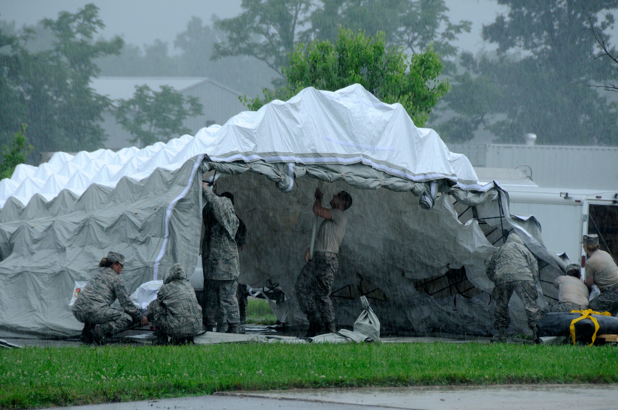Members of the 182nd Airlift Wing's CERFP medical element erect a triage tent during a rainstorm at the Boone County Fire District Training Center on June 17, 2015, near Columbia, Mo. (U.S. Air National Guard photo by Tech, Sgt. Todd Pendleton)(Relased)