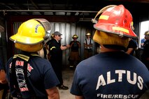 ALTUS AIR FORCE BASE, Okla. – Firefighters from Altus and Frederick prepare to receive structural live fire training, June 24, 2015. During this training, the firefighters were taught how to cool down and clear smoke out of a room through a process called hydraulic ventilation. They also received confined space entry maze training and forcible entry door training. (U.S. Air Force photo by Airman 1st Class Megan E. Acs/Released)