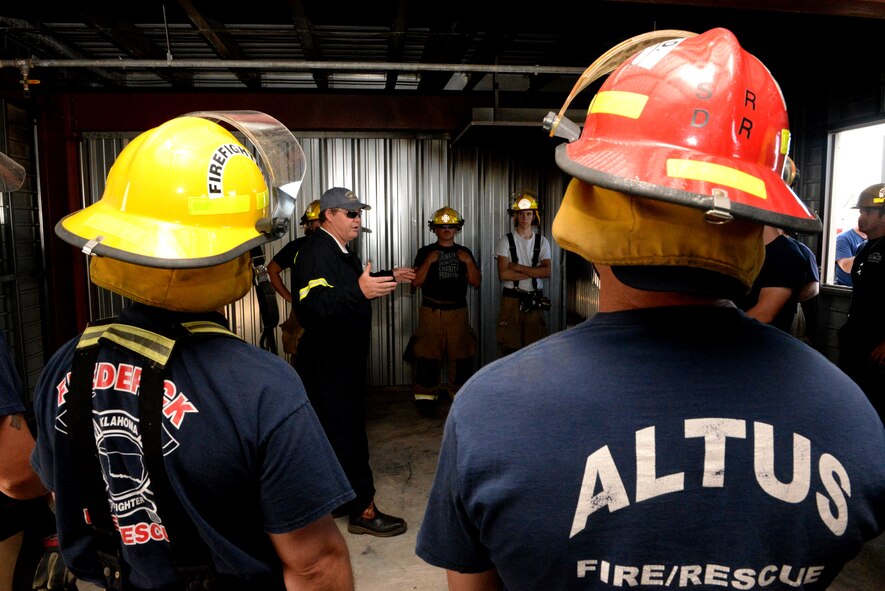 ALTUS AIR FORCE BASE, Okla. – Firefighters from Altus and Frederick prepare to receive structural live fire training, June 24, 2015. During this training, the firefighters were taught how to cool down and clear smoke out of a room through a process called hydraulic ventilation. They also received confined space entry maze training and forcible entry door training. (U.S. Air Force photo by Airman 1st Class Megan E. Acs/Released)