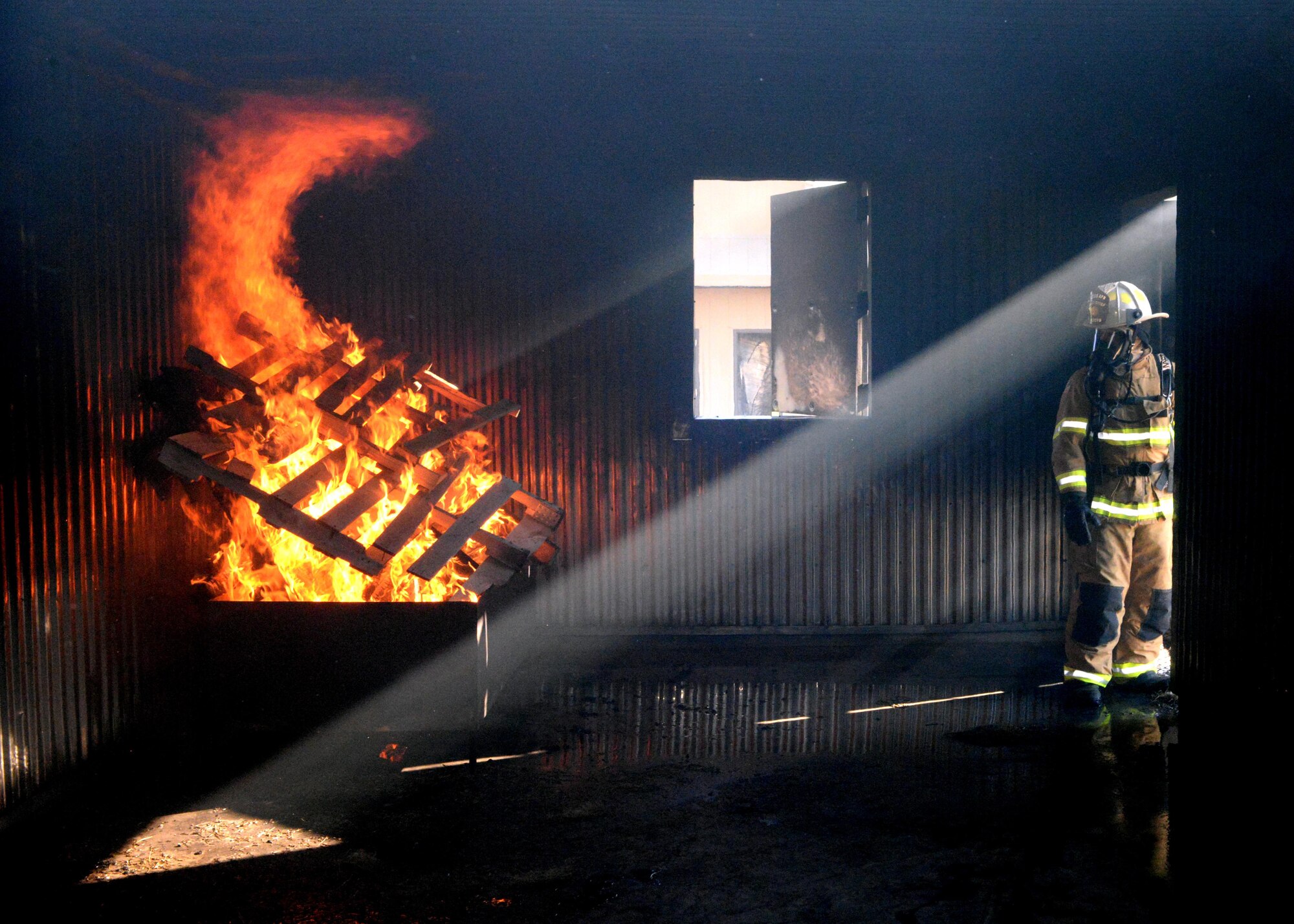 ALTUS AIR FORCE BASE, Okla. – U.S. Air Force Tech. Sgt. Ryan Boyd, 97th Civil Engineer Squadron Fire Emergency Services Flight assistant chief of operations, prepares a structural live fire training room for joint training with firefighters from Altus and Frederick, June 24, 2015. During the training, roughly 30 new firefighters received their first hands-on training with a live fire exercise. (U.S. Air Force photo by Airman 1st Class Megan E. Acs/Released)