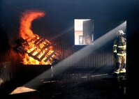 ALTUS AIR FORCE BASE, Okla. – U.S. Air Force Tech. Sgt. Ryan Boyd, 97th Civil Engineer Squadron Fire Emergency Services Flight assistant chief of operations, prepares a structural live fire training room for joint training with firefighters from Altus and Frederick, June 24, 2015. During the training, roughly 30 new firefighters received their first hands-on training with a live fire exercise. (U.S. Air Force photo by Airman 1st Class Megan E. Acs/Released)