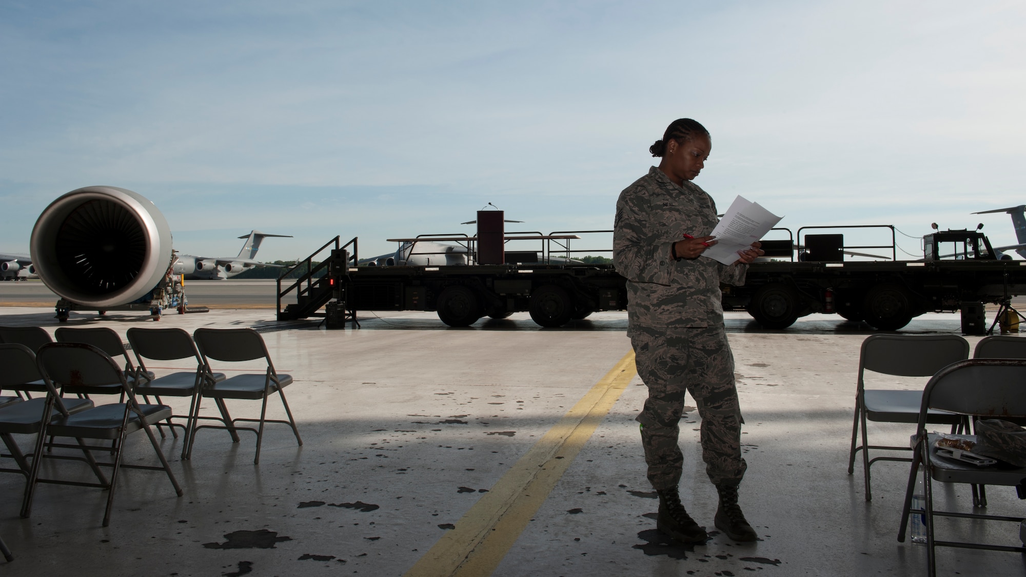 Staff Sgt. Evelyn Neal, 436th Airlift Wing Protocol specialist, reviews a retirement ceremony script during a retirement ceremony rehearsal June 25, 2015, at Dover Air Force Base, Del. The Protocol Office provides resources concerning different types of official Air Force ceremonies and events. (U.S. Air Force photo/Airman 1st Class Zachary Cacicia)