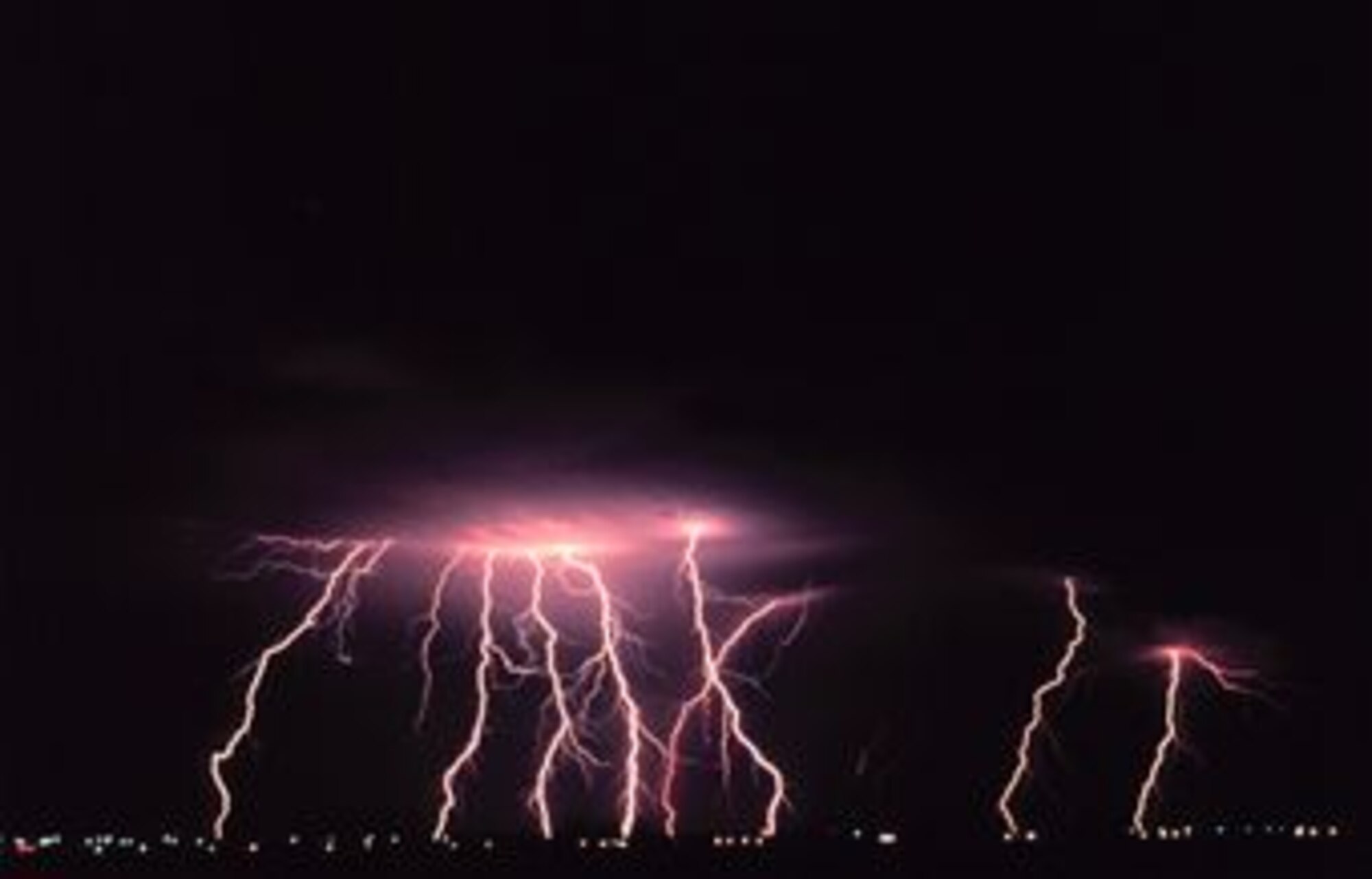 Time-lapse photography captures multiple cloud-to-ground lightning strokes during a night-time thunderstorm. (Photo courtesy of the National Severe Storms Laboratory) 