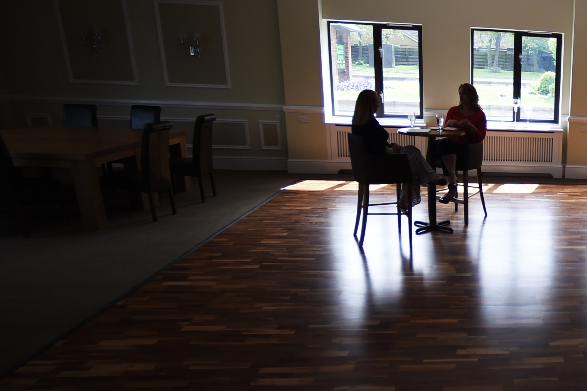 Katy Shipman, 423rd Medical Squadron key spouse, left, speaks with Janet Driggers, 501st Combat Support Wing key spouse, during an informal meeting at RAF Alconbury, United Kingdom, May 13, 2015. Key spouses serve as liaisons between Air Force spouses and base leadership. (U.S. Air Force photo by Staff Sgt. Jarad A. Denton/Released)