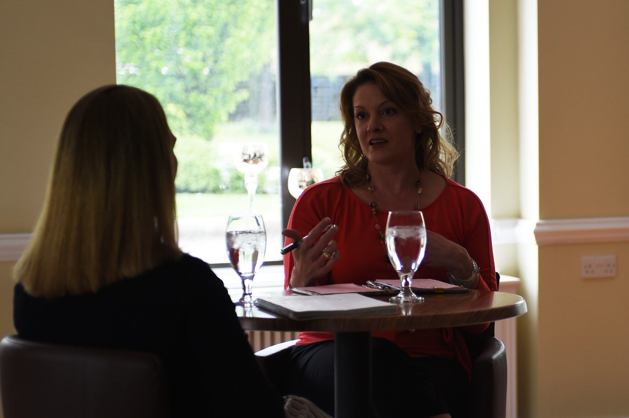 Katy Shipman, 423rd Medical Squadron key spouse, left, speaks with Janet Driggers, 501st Combat Support Wing key spouse, during an informal meeting at RAF Alconbury, United Kingdom, May 13, 2015. Key spouses serve as liaisons between Air Force spouses and base leadership. (U.S. Air Force photo by Staff Sgt. Jarad A. Denton/Released)