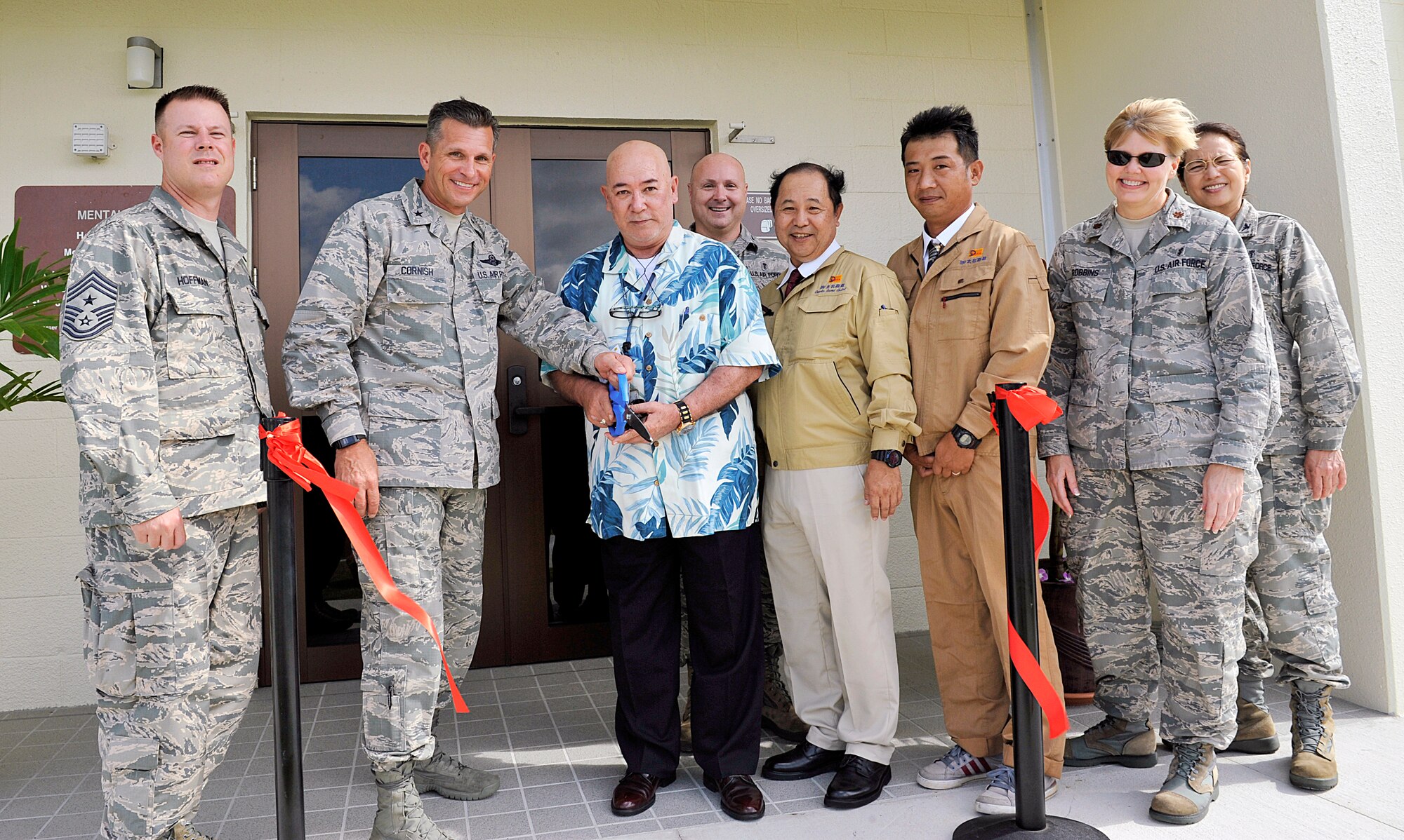 U.S. Air Force Brig. Gen. Barry Cornish, 18th Wing commander, and Karl Yamashiro, 18th Medical Group facilities administrator, cut a ribbon for the Mental Health Clinic relocation opening ceremony on Kadena Air Base, Japan, July 1, 2015. The Kadena Mental Health Clinic, previously located at Bldg. 856, has relocated to a newly renovated facility near Marek Park. The $4.3 million project was completed on May 26. (U.S. Air Force photo by Naoto Anazawa)