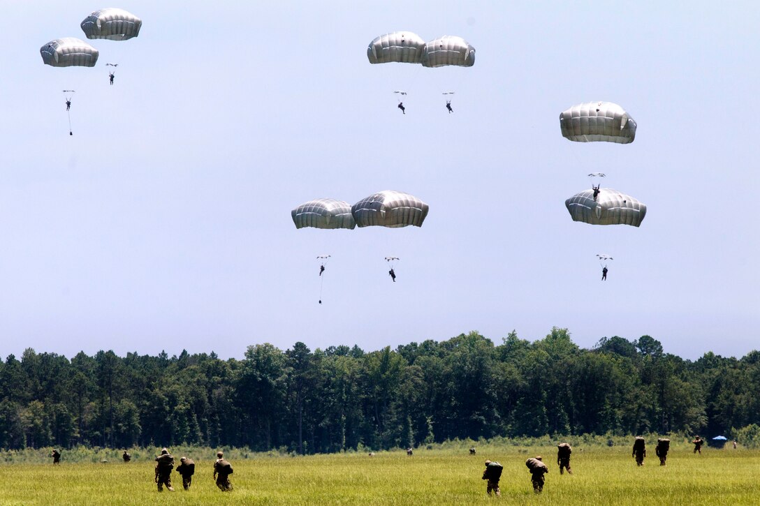 Army Rangers descend to the ground during military free-fall operations to kick off the 2015 Ranger Rendezvous at Fryar Drop Zone on Fort Benning, Ga., June 22, 2015.