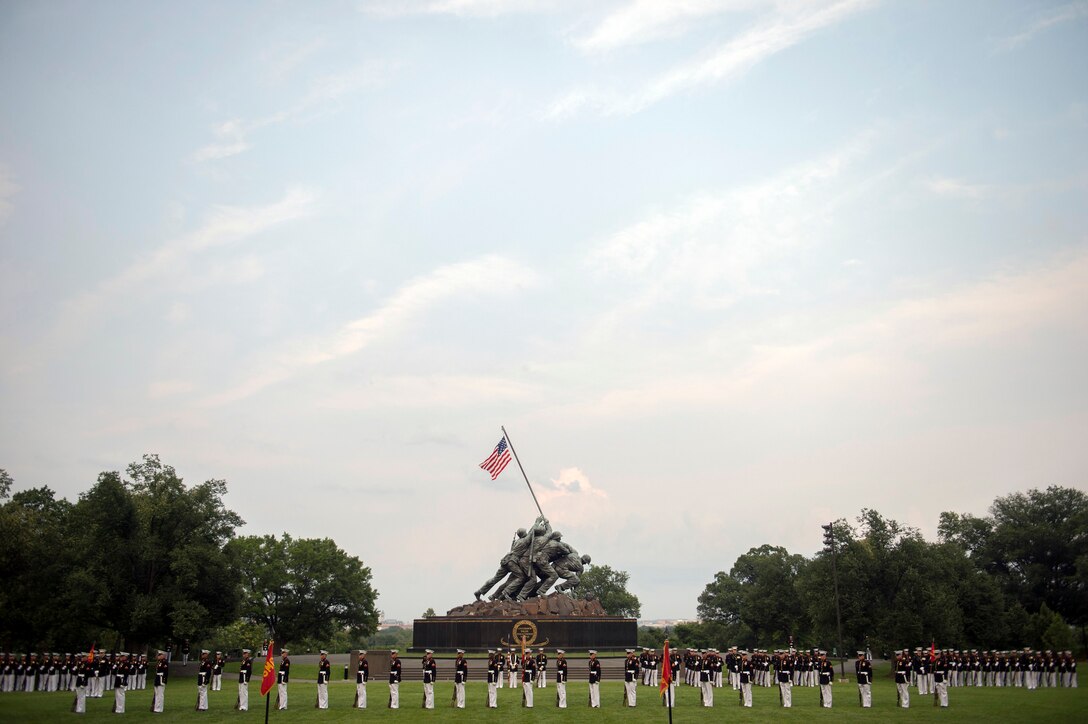 The Marine Corps Silent Drill Platoon performs during the Marine Corps Sunset Parade at the Iwo Jima Memorial in Arlington, Va., June 30, 2015.