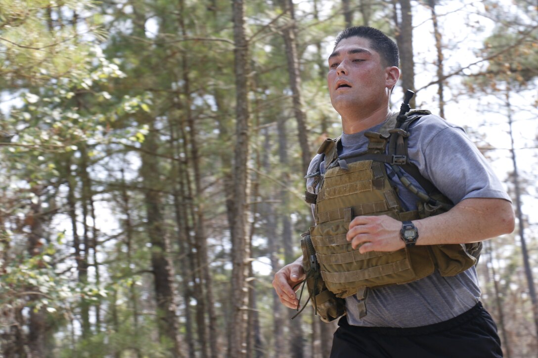 Army Staff Sgt. Michael Ballou nears the end of a three-mile body-armor run during long range surveillance selection on Fort Bragg, June 23, 2015. Candidates were ideally expected to complete the run in 24 minutes or less, despite the adverse weather conditions. Ballou is an infantryman assigned to the Division's 2nd Battalion, 87th Infantry Regiment, 2nd Brigade Combat Team.