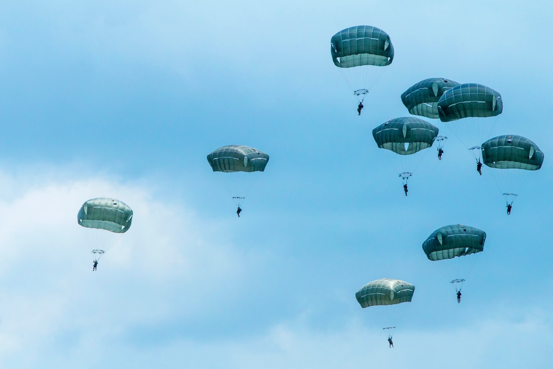 Army Rangers descend to the ground during military free-fall operations ...