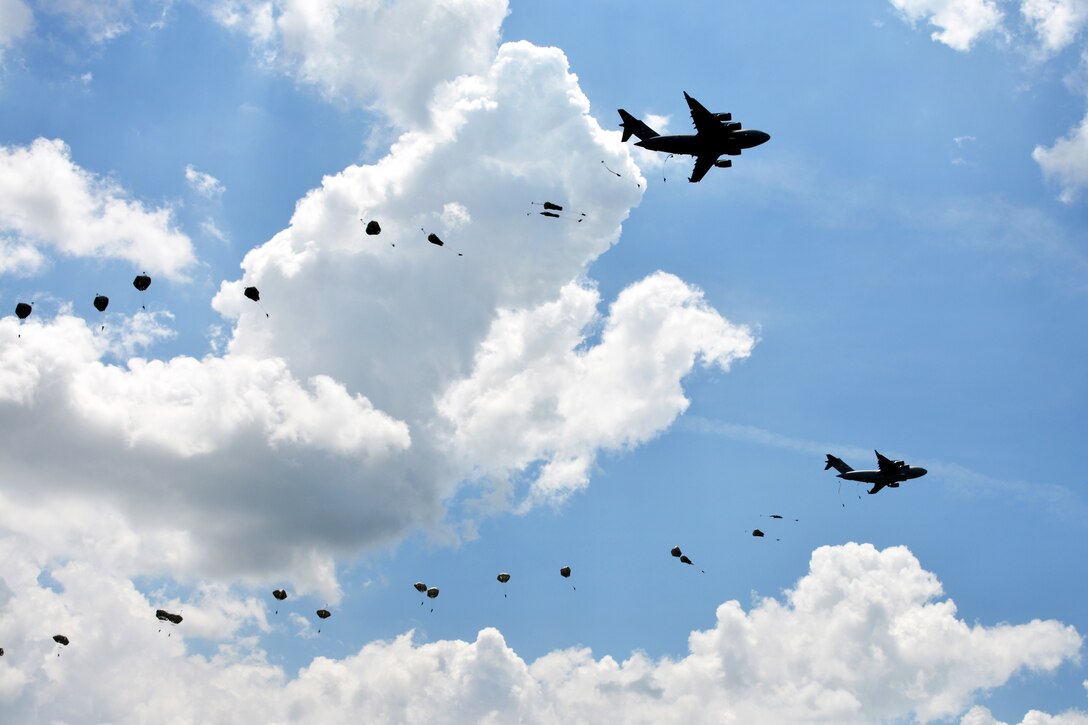 Army Rangers jump from C-17 aircraft during military free-fall operations to kick off the 2015 Ranger Rendezvous at Fryar Drop Zone on Fort Benning, Ga., June 22, 2015. The soldiers are assigned to the Regimental Special Troops Battalion, 75th Ranger Regiment.