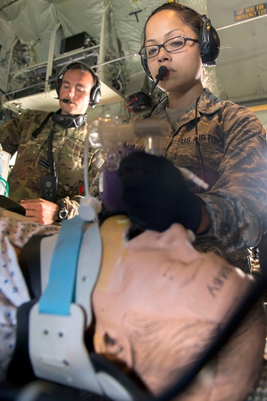 Air Force Tech. Sgt. Maria Cordova treats a mock patient during a medical evacuation mission during Patriot Warrior on Fort McCoy, Wis., June 20, 2015. Cordova is a respiratory therapist assigned to the 459th Aeromedical Staging Squadron.