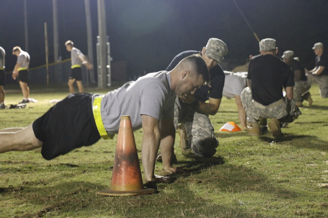 Long-range surveillance selection candidates participate in the push-up event of a qualifying Ranger Physical Fitness Test on Fort Bragg, N.C., June 22, 2015. Nineteen candidates started their morning competing for a chance to be a part of F Company Headquarters Battalion, XVIII Airborne Corps.