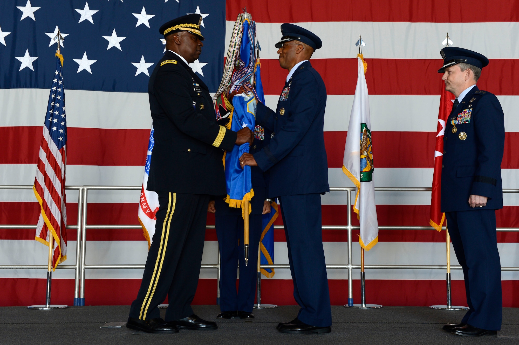 U.S. Air Force Lt. Gen. Charles Q. Brown Jr., U.S. Air Forces Central Command commander receives the AFCENT guidon from U.S. Army Gen. Lloyd J. Austin III, U.S. Central Command commander, during a change of command ceremony at Shaw Air Force Base, S.C., June 29, 2015. Outgoing and incoming commanders exchange unit guidons to symbolize relinquishment and assumption of command. (U.S. Air Force photo by Senior Airman Jensen Stidham/Released)