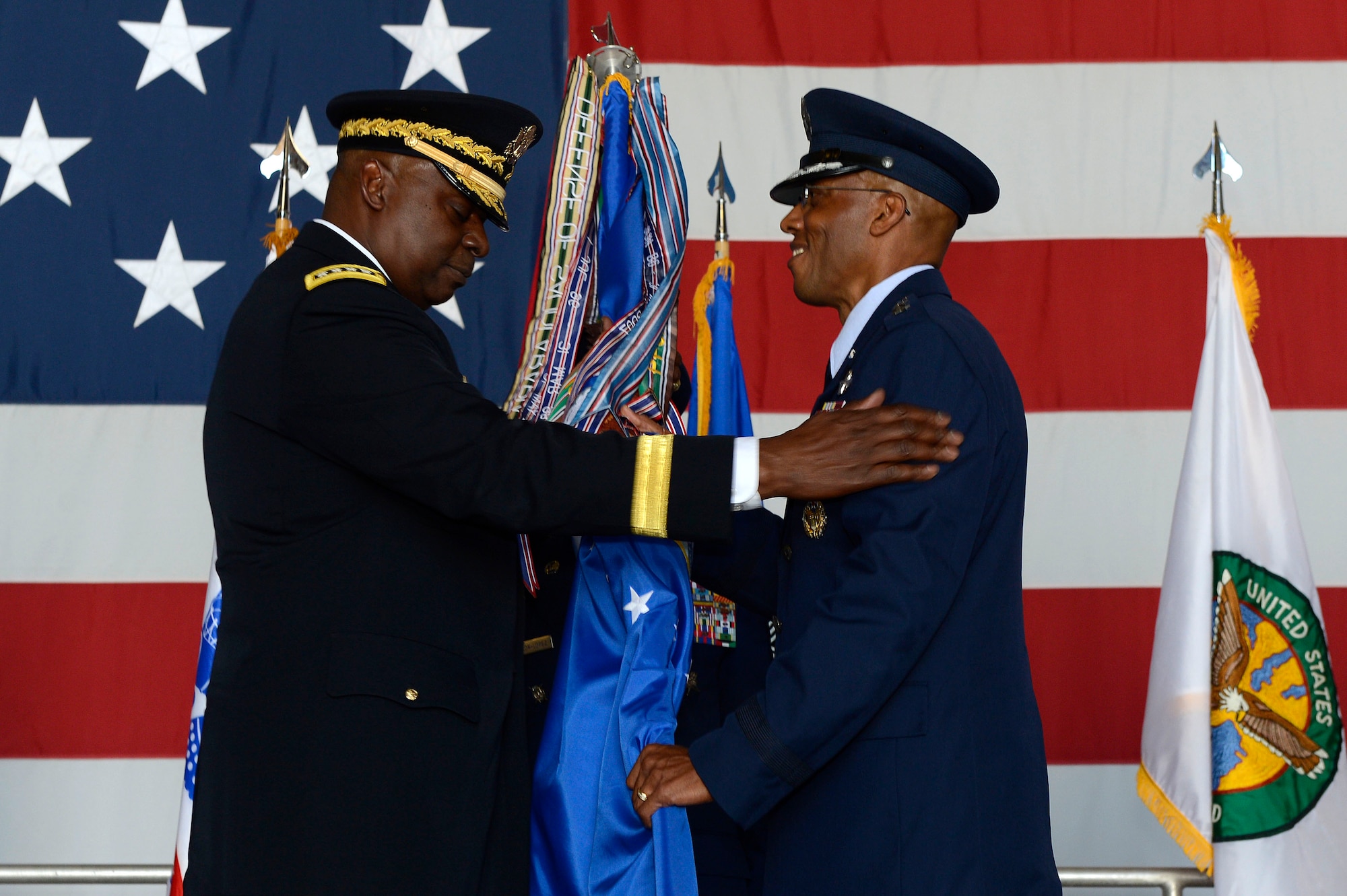 U.S. Air Force Lt. Gen. Charles Q. Brown Jr., U.S. Air Forces Central Command commander receives the AFCENT guidon from U.S. Army Gen. Lloyd J. Austin III, U.S. Central Command commander, during a change of command ceremony at Shaw Air Force Base, S.C., June 29, 2015. Outgoing and incoming commanders exchange unit guidons to symbolize relinquishment and assumption of command. (U.S. Air Force photo by Senior Airman Jensen Stidham/Released)