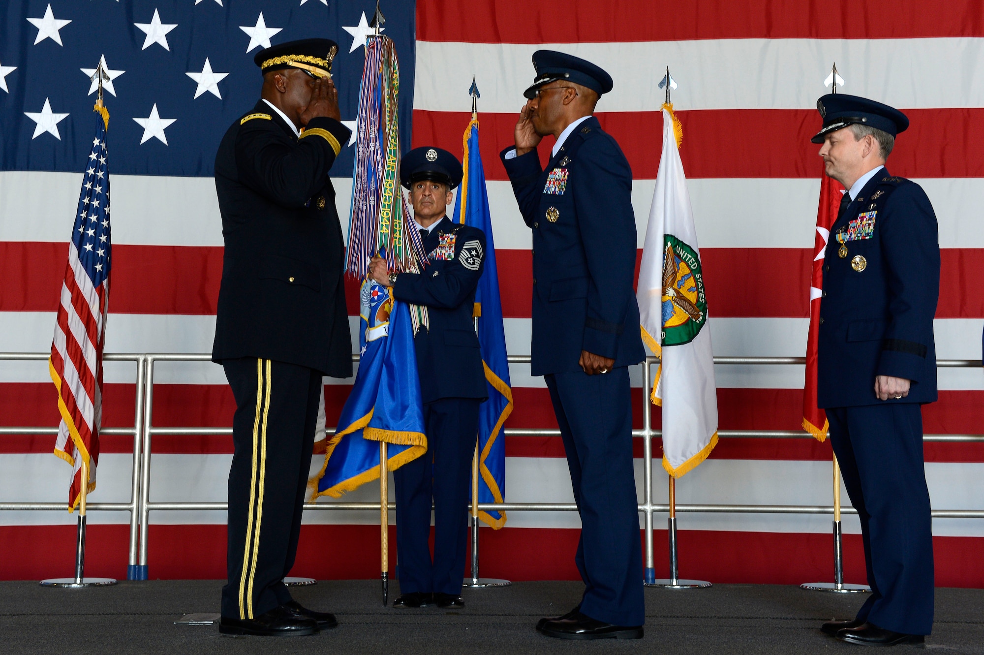 U.S. Air Force Lt. Gen. Charles Q. Brown Jr., U.S. Air Forces Central Command commander salutes U.S. Army Gen. Lloyd J. Austin III, U.S. Central Command commander, during a change of command ceremony at Shaw Air Force Base, S.C., June 29, 2015. Outgoing and incoming commanders exchange unit guidons to symbolize relinquishment and assumption of command. (U.S. Air Force photo by Senior Airman Jensen Stidham/Released)