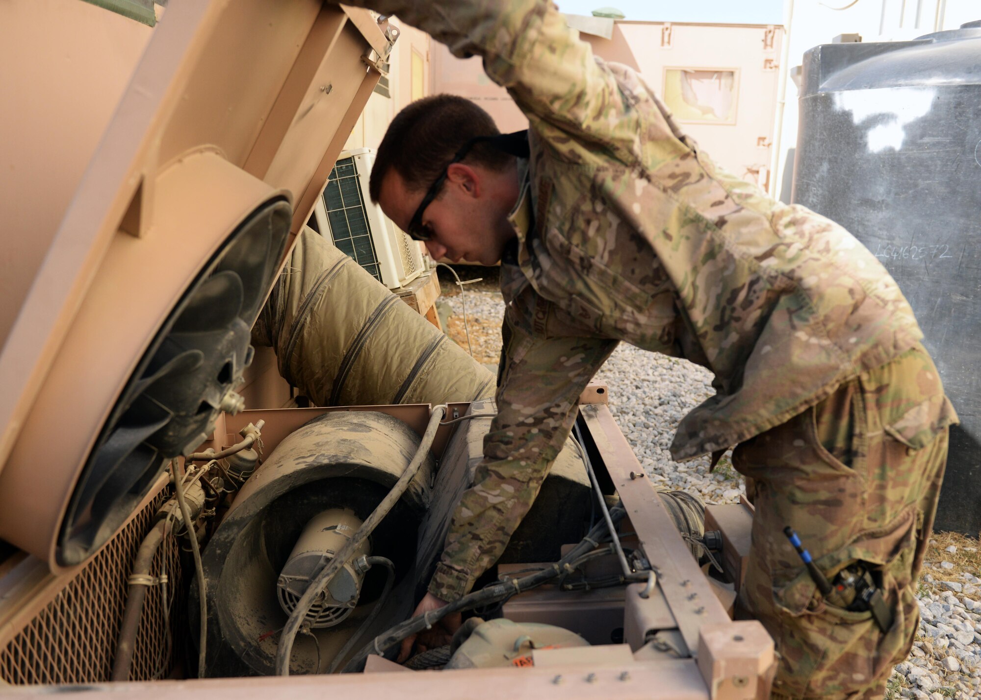 U.S. Air Force Staff Sgt. Russell Dutcher, 455th Expeditionary Civil Engineer Squadron HVAC technician, repairs an air conditioning unit June 30, 2015, at Bagram Airfield, Afghanistan. Dutcher, who is part of the 1000s of Hands project, is responsible for responding to all work orders dealing with AC problems as well as keeping Bagram’s mission equipment such as computers and servers cool. (U.S. Air Force photo By Senior Airman Cierra Presentado/Released)