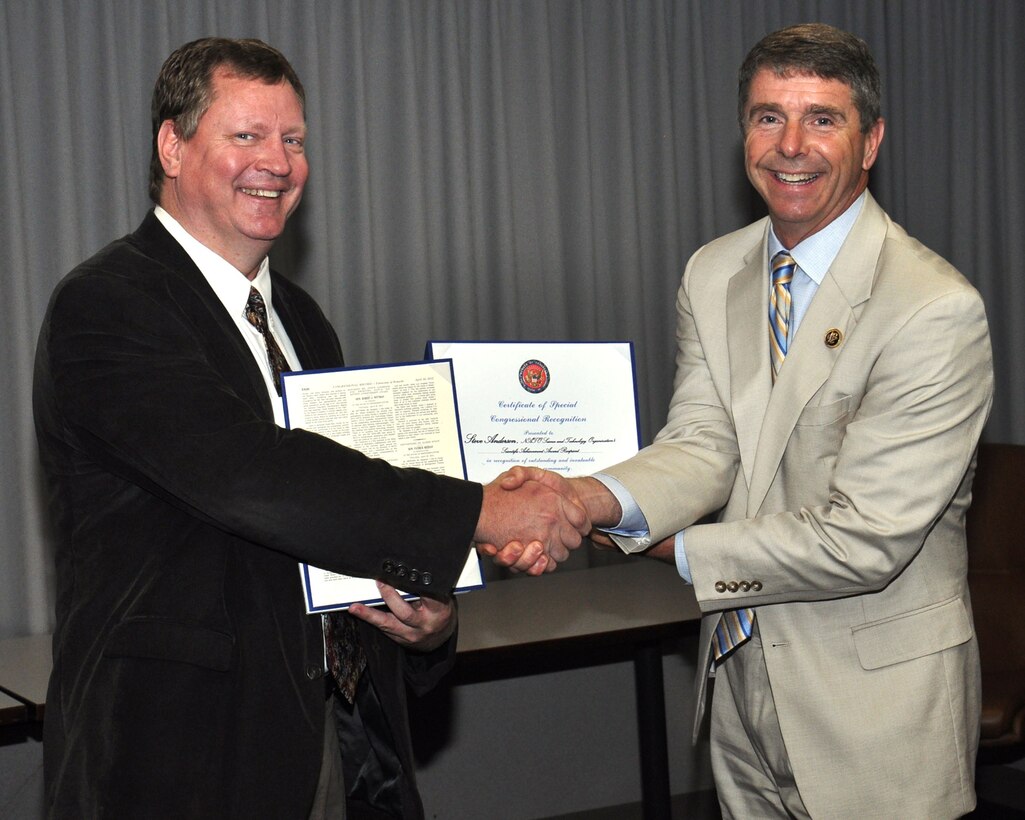 U.S. Rep. Rob Wittman (R-VA) congratulates Naval Surface Warfare Center Dahlgren Division (NSWCDD) scientist Steve Anderson for his NATO Science and Technology Organization's Scientific Achievement Award May 18.  