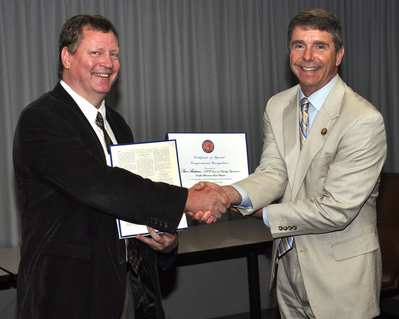 U.S. Rep. Rob Wittman (R-VA) congratulates Naval Surface Warfare Center Dahlgren Division (NSWCDD) scientist Steve Anderson for his NATO Science and Technology Organization's Scientific Achievement Award May 18.  