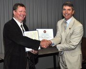 U.S. Rep. Rob Wittman (R-VA) congratulates Naval Surface Warfare Center Dahlgren Division (NSWCDD) scientist Steve Anderson for his NATO Science and Technology Organization's Scientific Achievement Award May 18.  