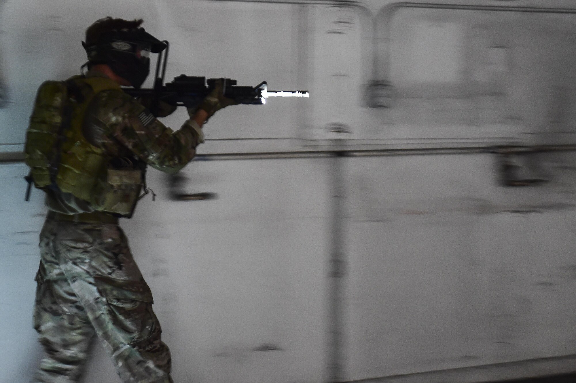 Airman 1st Class Joshua Belton, 1st Special Operations Security Forces Squadron Deployed Aircraft Ground Response Element simulates assault drills during close-quarters combat training in Fort Walton Beach, Fla., June 19, 2015. The FTX simulated the DAGRE team escorting a finance specialist to make a transfer of funds. (U.S. Air Force photo/Senior Airman Jeff Parkinson)