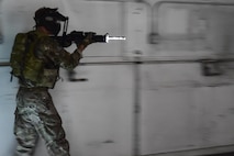 Airman 1st Class Joshua Belton, 1st Special Operations Security Forces Squadron Deployed Aircraft Ground Response Element simulates assault drills during close-quarters combat training in Fort Walton Beach, Fla., June 19, 2015. The FTX simulated the DAGRE team escorting a finance specialist to make a transfer of funds. (U.S. Air Force photo/Senior Airman Jeff Parkinson)