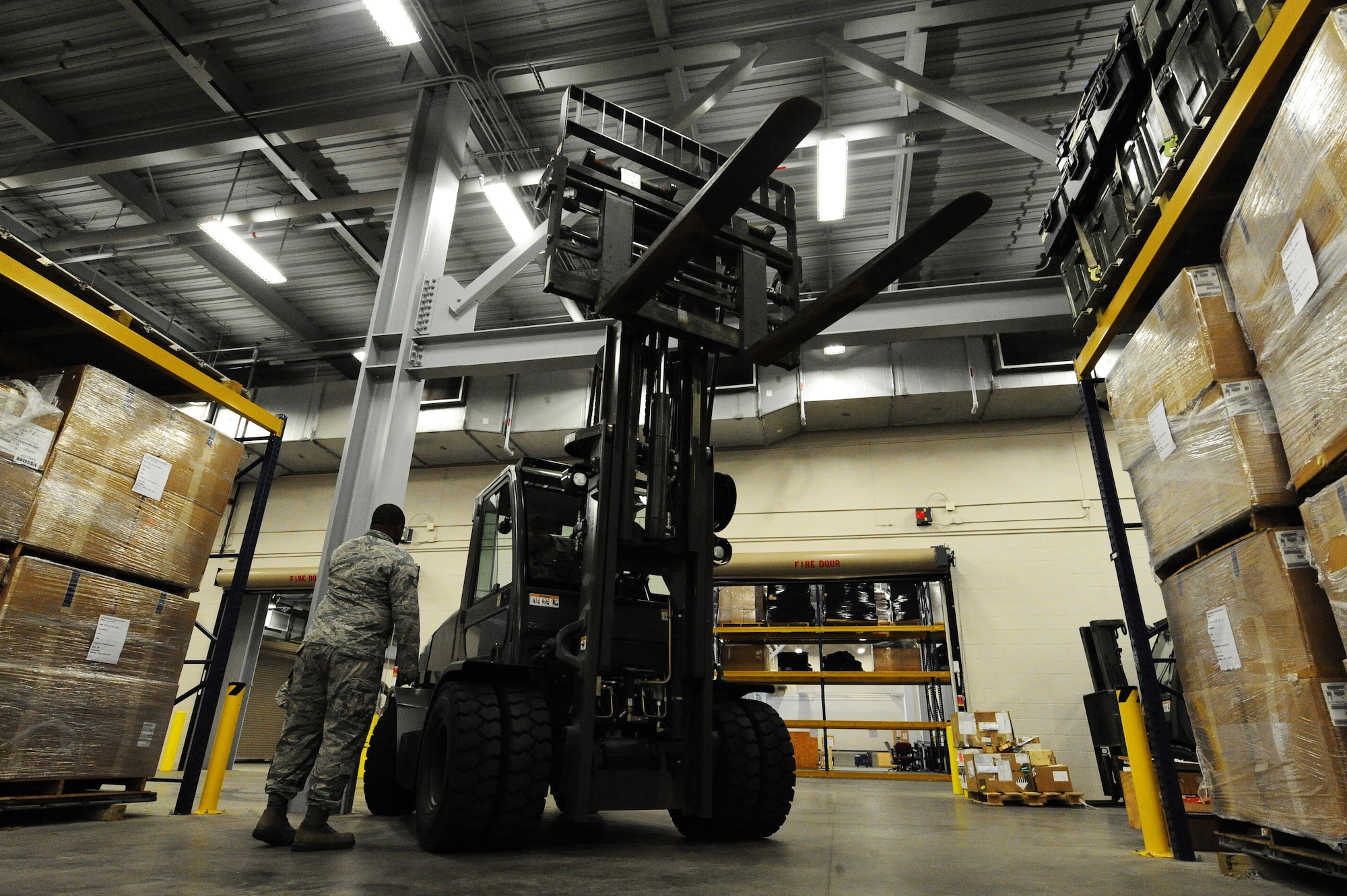Staff Sgt. Darius Brown, 1st Special Operations Logistics Readiness Squadron materiel management flight service center supervisor, directs a 4k fork lift at Hurlburt Field, Fla., June 29, 2015. The materiel management flight stocks, stores, issues and receives 27,400 line items of supplies and equipment for Hurlburt Field. (U.S. Air Force photo/Airman 1st Class Andrea Posey)