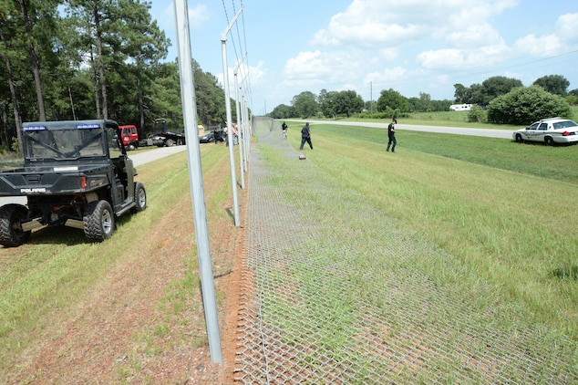 A portion of Marine Corps Logistics Base Albany's fence line is damaged after a one-car accident on Fleming Road, July 1.