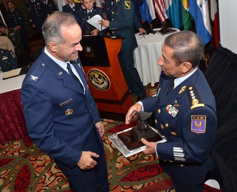 U.S. Air Force Col. Alberto Moreno-Bonet, the secretary general of the System of Cooperation Among the American Air Forces, accepts a gift from Commander of the Mexican air force Gen. Carlos Antonio Rodriguez Munguia during the Conference of American Air Chiefs June 25, 2015, in Mexico City. (U.S. Air Force photo/Capt. Bryan Bouchard)