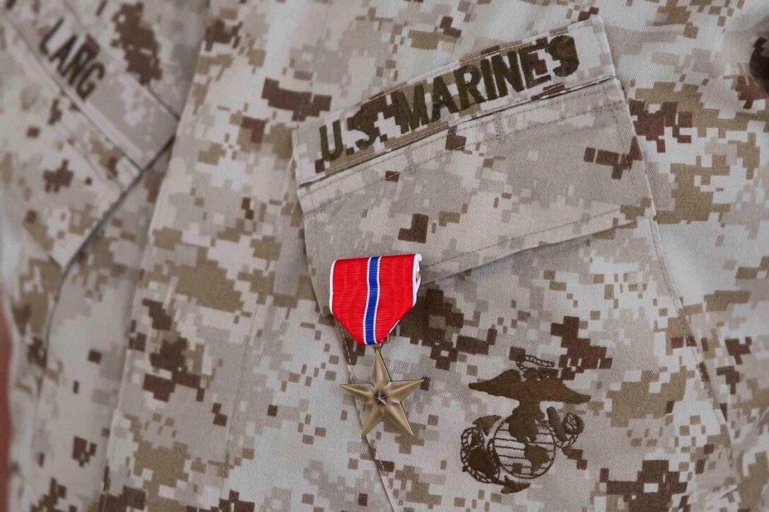 Lieutenant Col. Peter J. Lang II, officer in charge, Georgia Deployment Program, International Security Assistance Force-Rotation 14, and mentor to the 51st Georgian Light Infantry Battalion commander, is awarded the Bronze Star Medal by Lt. Gen. David H. Berger, the commanding general of I Marine Expeditionary Force, June 29, 2015. The Bronze Star Medal is an individual military award of the U.S. armed forces that may be awarded for acts of heroism, merit or meritorious service in a combat zone.
