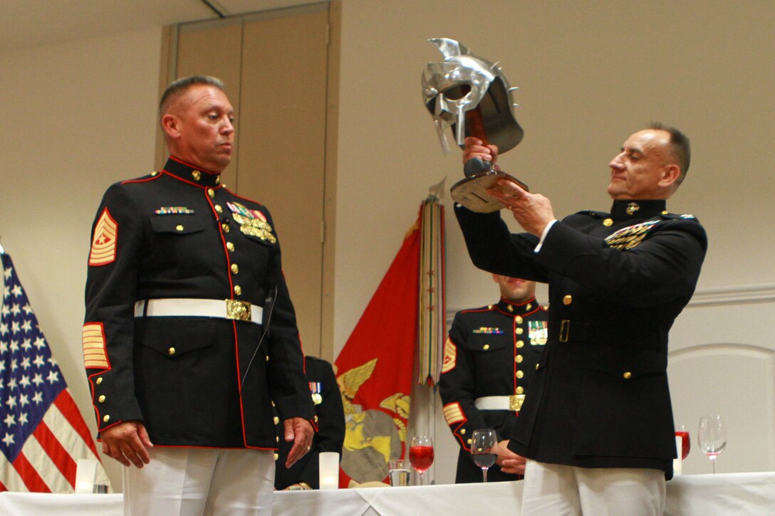 Sergeant Maj. Darryl Sisneros, the sergeant major of I Marine Headquarters Group, I Marine Expeditionary Force, and the president of the mess, presents a token of appreciation to the guest of honor, Col. James H. Herrera, the I MHG commanding officer, during a mess night in Carlsbad, California, June 18, 2015. Sisneros described mess night as a time for Marines to strengthen the customs and traditions of the corps and reaffirm their common bonds as Marines. (U.S. Marine Corps photo by Lance Cpl. Caitlin Bevel)