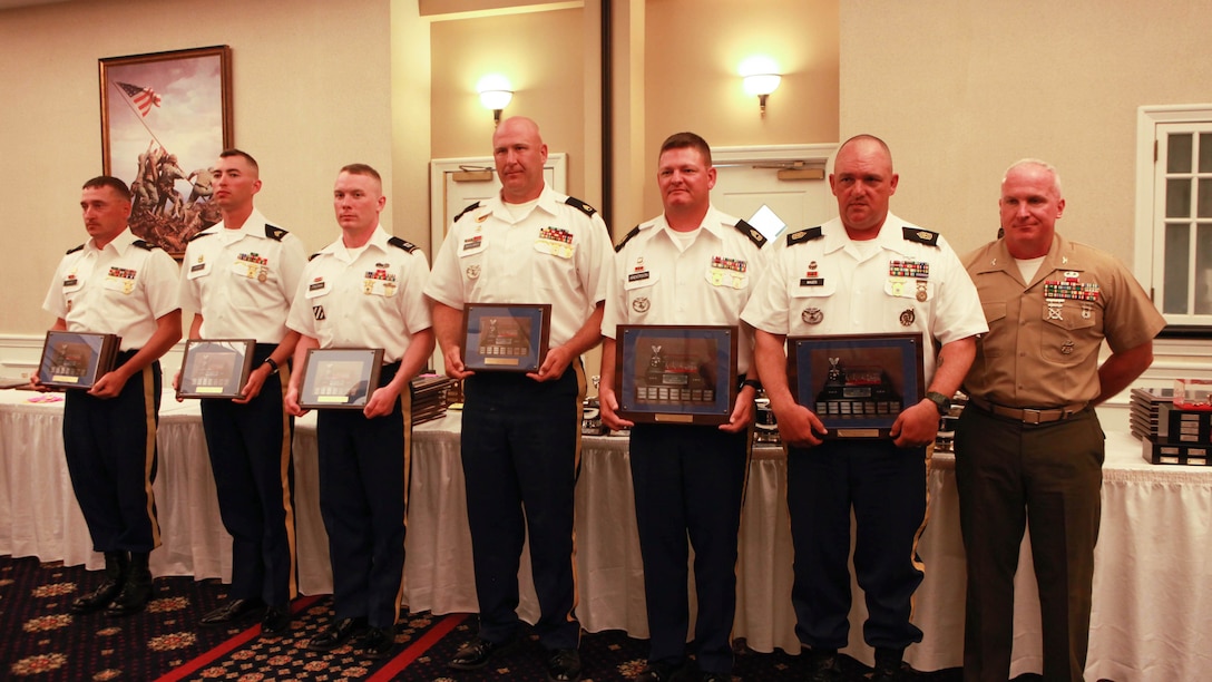 Soldiers with U.S. Army Reserve Team Anderson pose for a photo with Col. Timothy Parker during the awards banquet of the 54th Interservice Rifle Championship at Marine Corps Base Quantico, Virginia, July 1, 2015. The team won the Commanding General, Marine Corps Combat Development Command Team Match with a score of 1767.