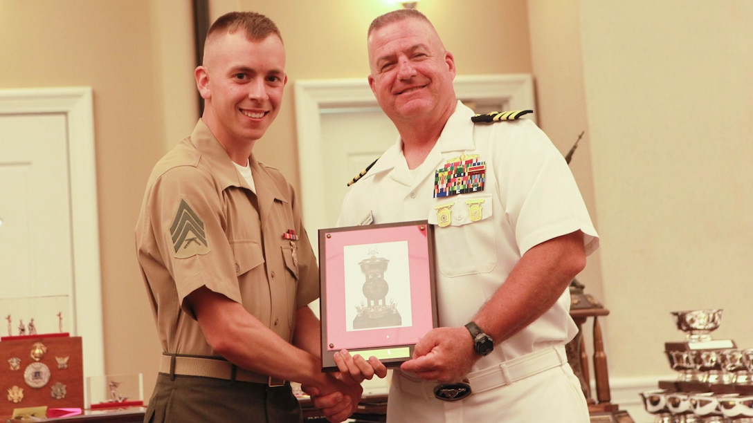 Sgt. Joseph Dukich (left) receives an award from U.S. Navy Cmdr. Mick Glancey during the award ceremony for the 54th Interservice Rifle Championship at Marine Corps Base Quantico, Virginia, July 1, 2015. Dukich received the award for placing second in the Interservice Coast Guard Match with a score of 200. Glancey is the commanding officer of the U.S. Navy Shooting Team.