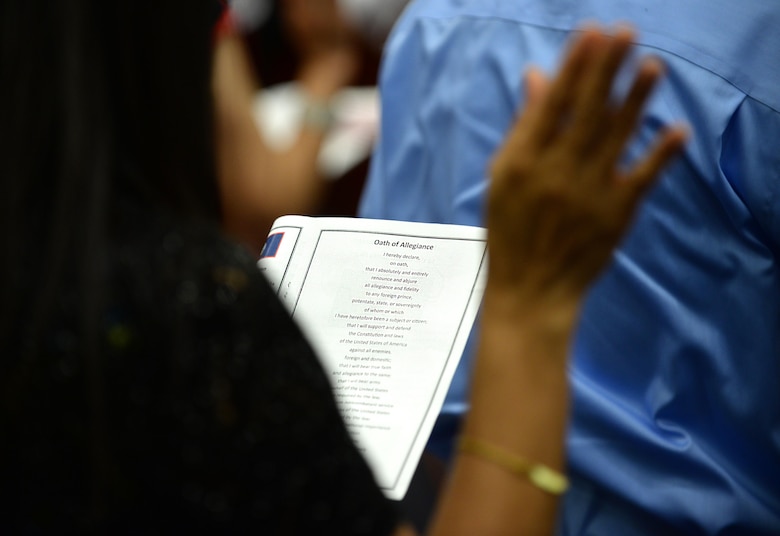 A new U.S. citizen reads the Oath of Allegiance July 2, 2015, in Hagåtña, Guam. Twenty-four applicants received their U.S citizenship during a naturalization ceremony held in conjunction with Independence Day weekend. (U.S. Air Force photo by Senior Airman Alexander W. Riedel/Released)