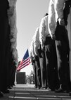 Members of the 747th Communications Squadron stand at attention prior to a Reveille ceremony on Joint Base Pearl Harbor-Hickam, Hawaii, July 2, 2015. The ceremony was held to honor the upcoming Fourth of July holiday. This year, the United States of America celebrates 239 years of independence.  (U.S. Air Force graphic by Tech. Sgt. Aaron Oelrich by Released) 